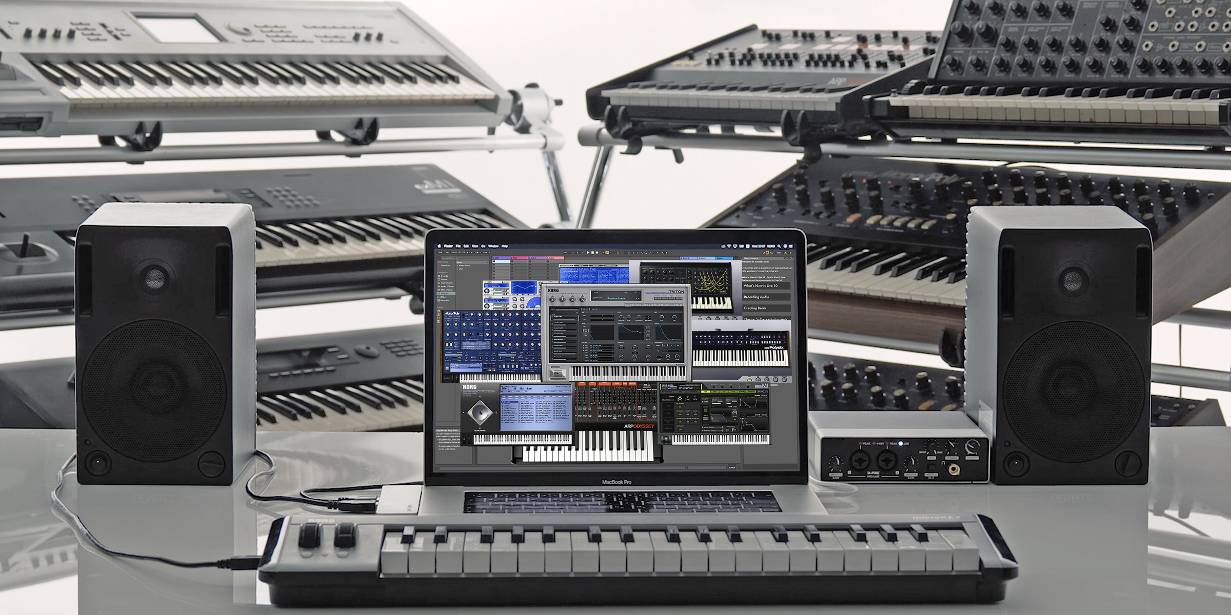 Los diversos plugins de Korg Collection 4 están siendo ejecutados sobre un ordenador de producción musical, "divisados" al fondo por las unidades reales e históricas